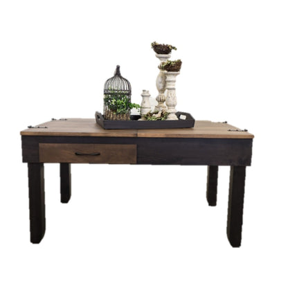 A jigsaw puzzle coffee table with a light wood top, a dark brown drawer, and dark legs, styled with a decorative tray, birdcage, and candle holders on a white background.