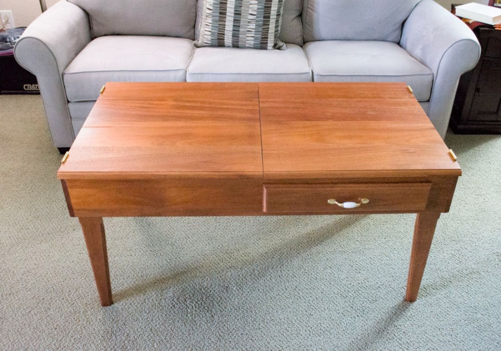 Wooden jigsaw puzzle coffee table with a gray sofa in the background