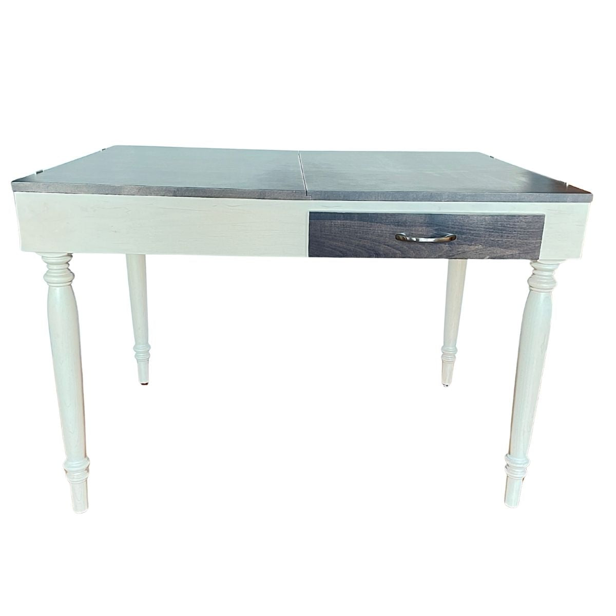 A white wooden jigsaw puzzle table with a dark wood grain top, featuring a single drawer with a dark wood front and a silver metal pull handle, set against a plain white background.