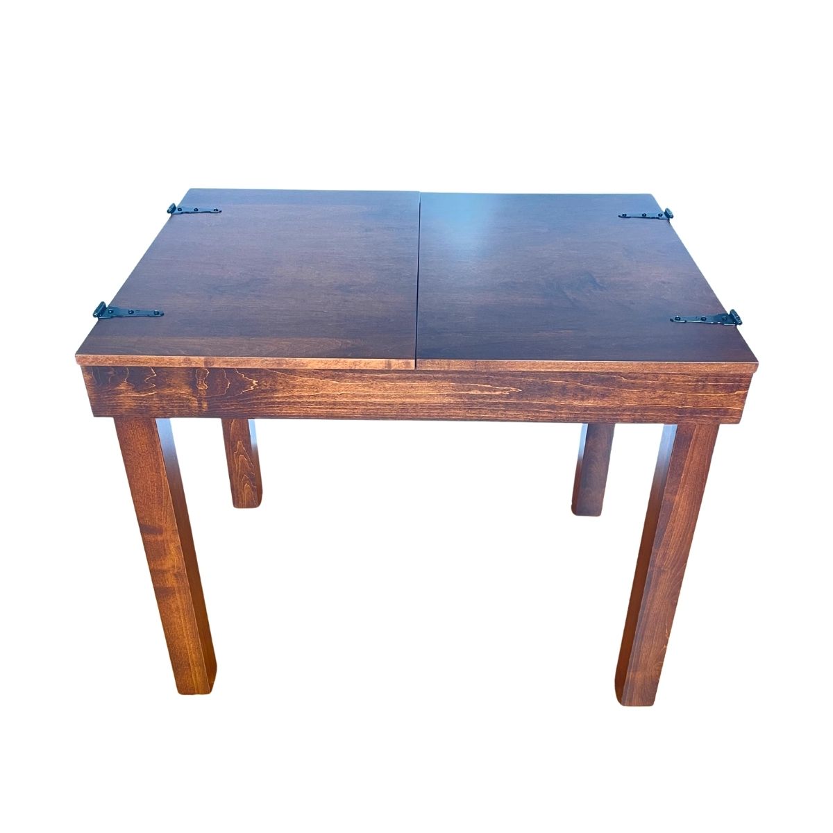 A cherry stained jigsaw puzzle table with a split top fully closed with four legs and metal corner brackets on a plain white background.